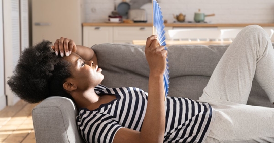 humid woman fanning herself
